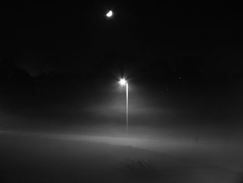 Low angle view of illuminated street light at night