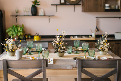 A beautiful festive dining table in the rustic style. dried flowers in a ceramic vase on the table
