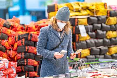 Midsection of woman standing in market during winter