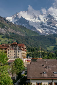 High angle view of buildings and mountains against sky