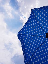 Low angle view of umbrella against sky