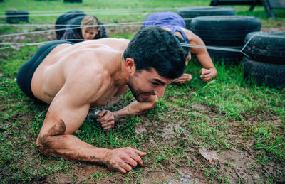 Friends crawling under strings on land