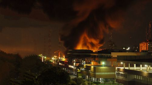 Panoramic view of illuminated city against sky at night