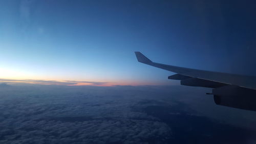 Airplane flying over clouds in sky