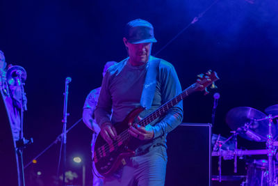 Man playing guitar at music concert