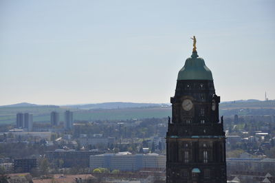 View of buildings in city against clear sky