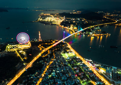 High angle view of city lit up at night