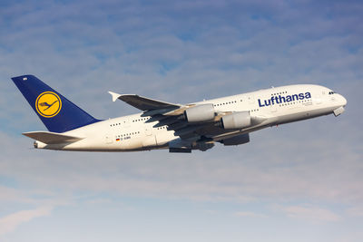 Low angle view of airplane flying against sky