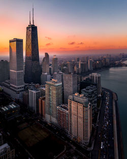 Aerial view of buildings in city during sunset