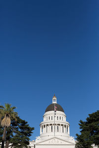 Low angle view of building against blue sky