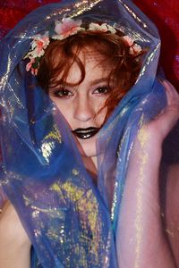 Close-up portrait of beautiful woman wearing flowers