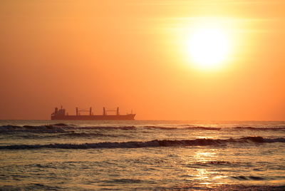 Scenic view of sea against orange sky