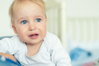 Cute baby boy looking away while crying