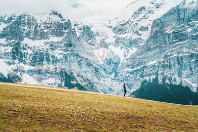 Woman looking at snowcapped mountain