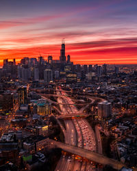 High angle view of illuminated city buildings at sunset