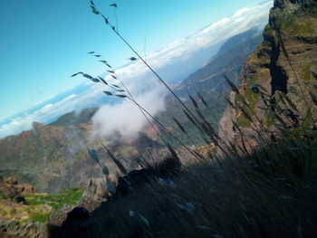 Scenic view of mountains against cloudy sky