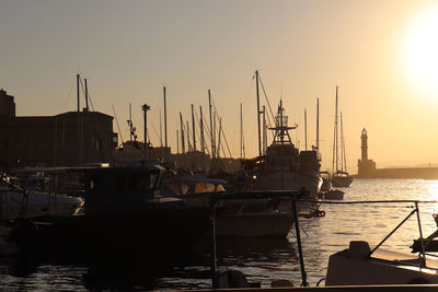 Sailboats in marina at sunset