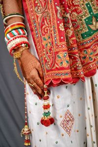 Midsection of woman with umbrella