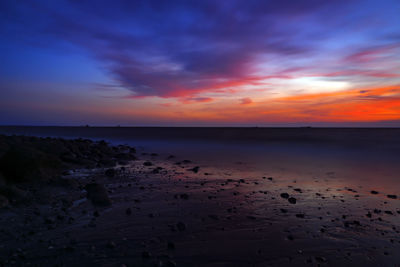 Scenic view of sea against romantic sky at sunset