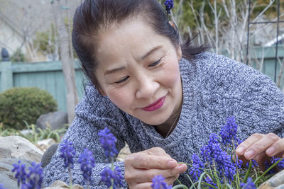 Portrait of smiling woman with purple flowers