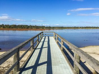 Pier on bibra lake and shore against sky