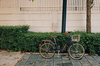 Bicycle parked against wall