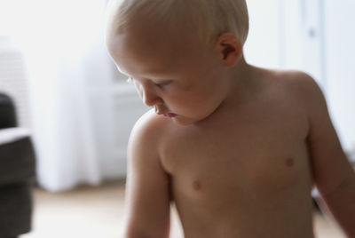 Close-up of shirtless boy at home