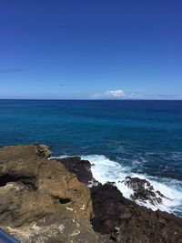 Scenic view of sea against blue sky