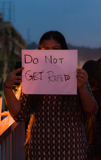 Portrait of woman with text against rape. 