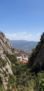 Scenic view of mountains and buildings against sky