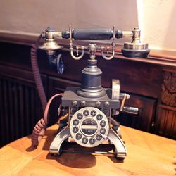 Close-up of telephone on wooden table