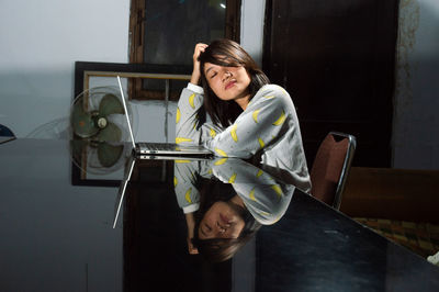 Woman sitting on table