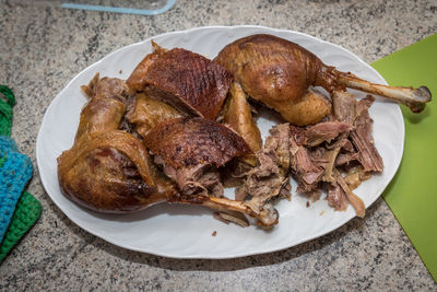 High angler view of roasted goose in plate on table