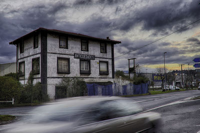 Road by building against sky