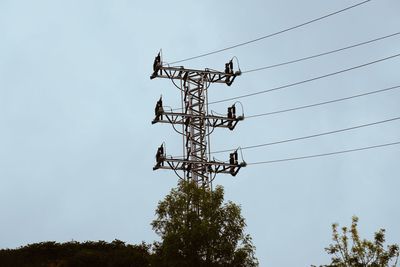 Low angle view of electricity pylon against sky