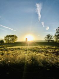 Scenic view of field against sky during sunset