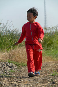 Side view of boy standing on field