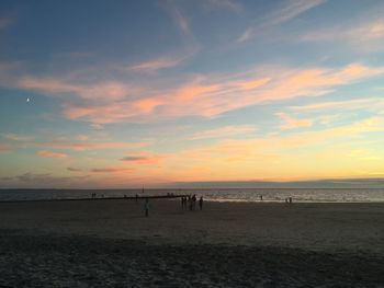 Scenic view of beach against sky during sunset