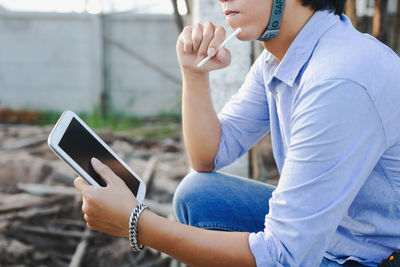 Midsection of woman using mobile phone