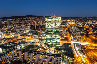 High angle view of illuminated buildings in city at night