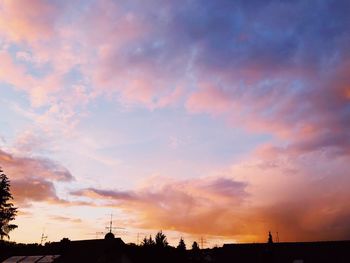 Low angle view of silhouette trees against sky during sunset