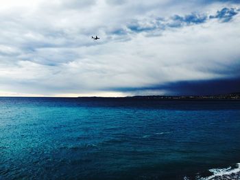 Scenic view of sea against cloudy sky