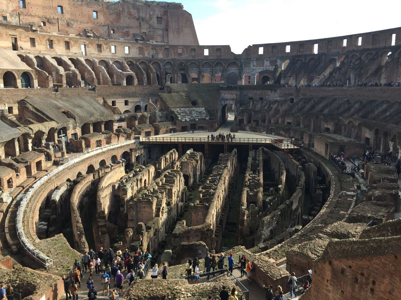 history, travel destinations, architecture, built structure, tourism, travel, amphitheater, city, ancient, real people, arts culture and entertainment, leisure activity, outdoors, building exterior, sport, large group of people, crowd, day, people, sky, ancient civilization