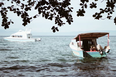 Boat sailing in sea against sky