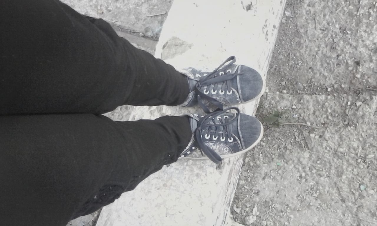 high angle view, shoe, low section, lifestyles, part of, leisure activity, personal perspective, men, street, person, unrecognizable person, footwear, shadow, day, cropped, holding, close-up