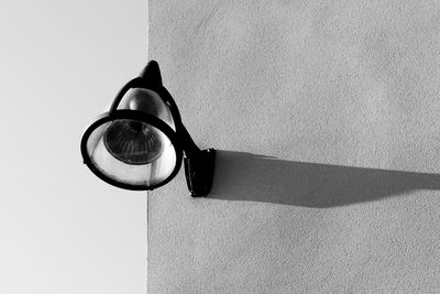 Close-up of wall lamp with shadow