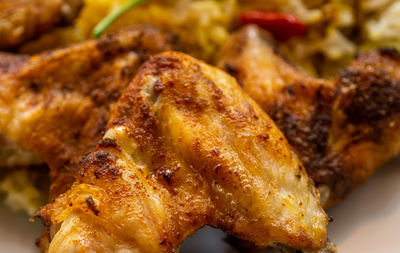 Grilled well seasoned crispy chicken wings close-up