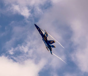 Low angle view of airplane flying in sky