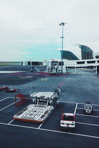 Airplane on airport runway against sky