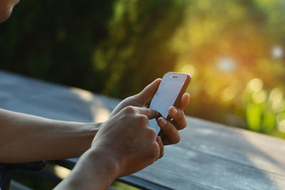 Midsection of man using mobile phone